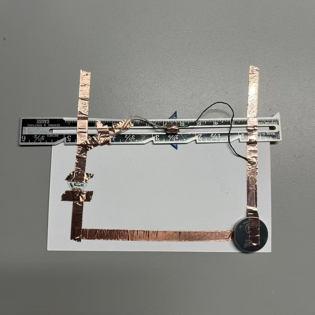 Using wool and a sliding iron ruler, allow the circuit to complete energization.