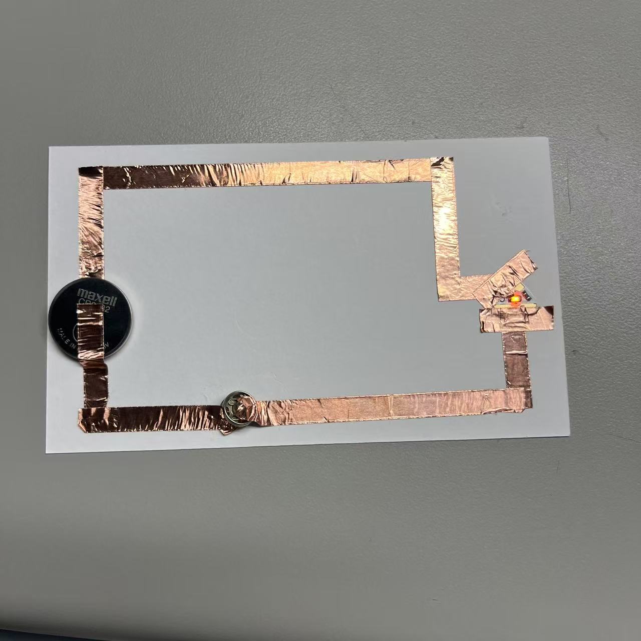 Circuits completed using metal buttons.